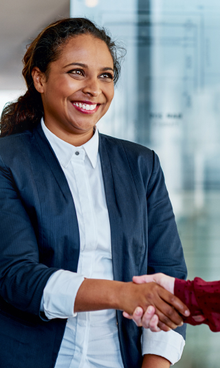 Image of a smiling woman shaking a hand