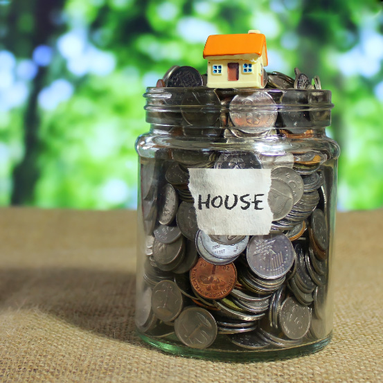 Image of a jar of coins labelled "House" with a miniature house on top