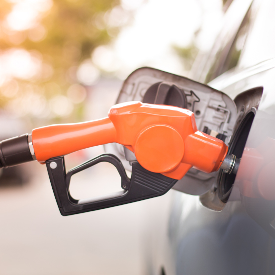 A close up image of a gas pump filling up a car