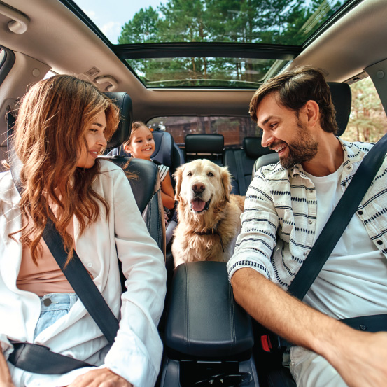 Family in car with dog.