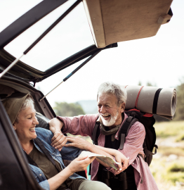 Image of two adults laughing in the back of a car
