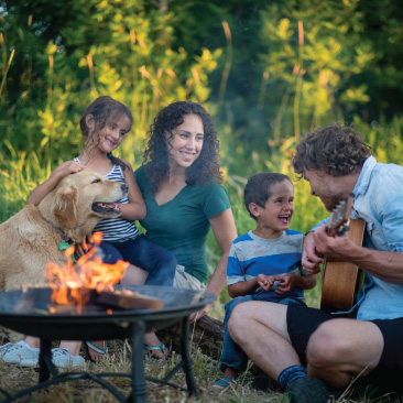 Image of a family around a campfire