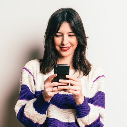 Image of a woman holding a phone