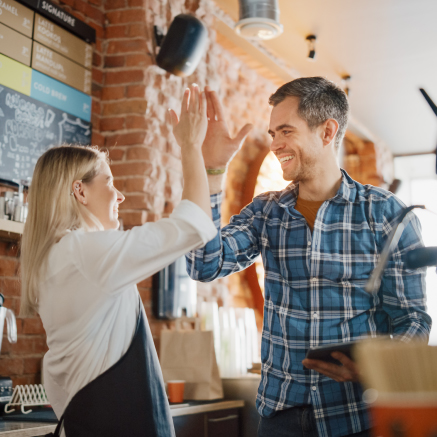 Business Owner High-fiving employee