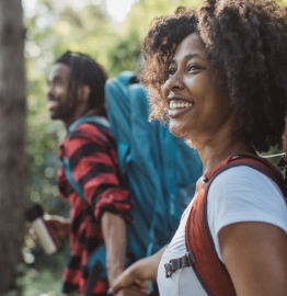 Image of a smiling couple holding hands outdoors