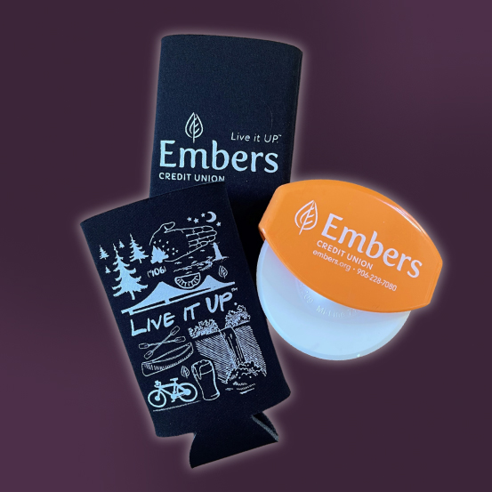Image of two drink koozies and pizza cutter, all branded with Embers graphics