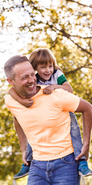 Image of a man with a child on his back