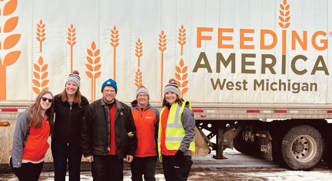 Embers Team Members volunteering for feeding America