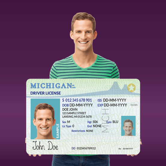 Man holding Michigan ID