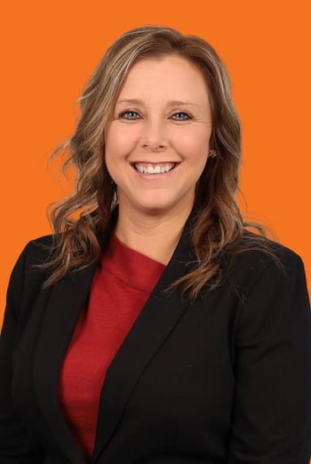 April headshot on orange