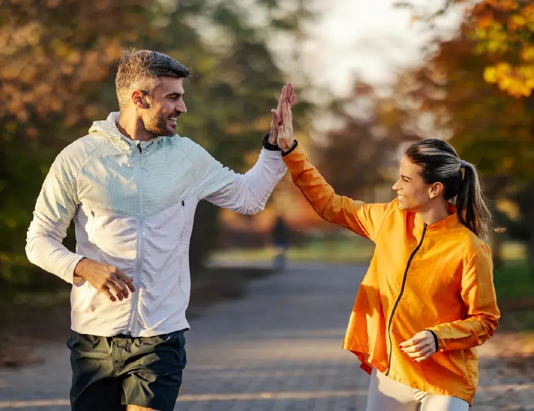 Couple Running and High-fiving