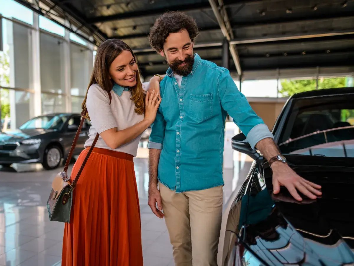 Couple looking at new car