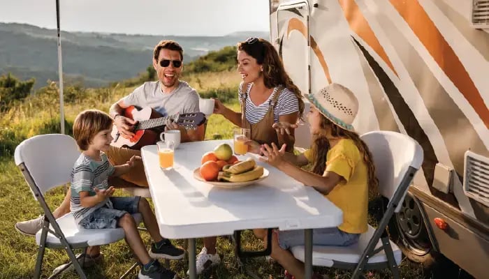 Family enjoying breakfast camping