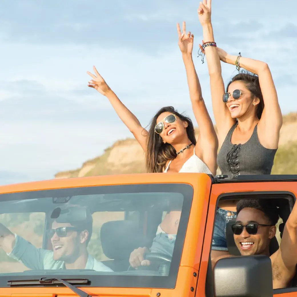 Friends in orange car having fun