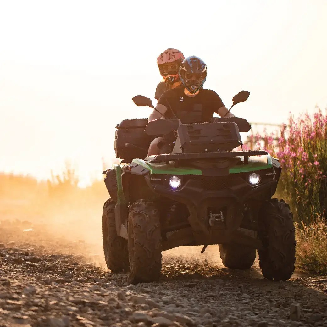 Man and woman riding on four wheeler