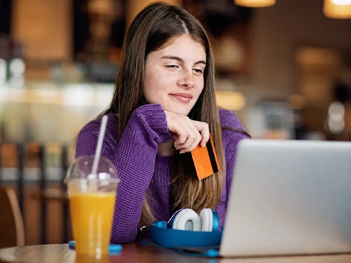 Teen Holding Debit Card