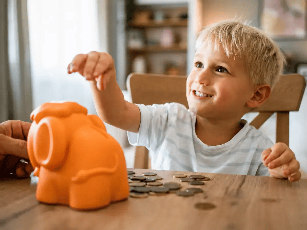 Young boy with piggy bank